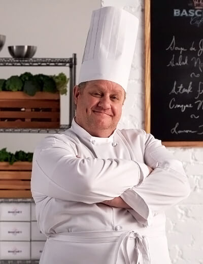 Chef standing in kitchen.