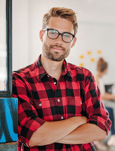 Smiling web design agency owner in an office