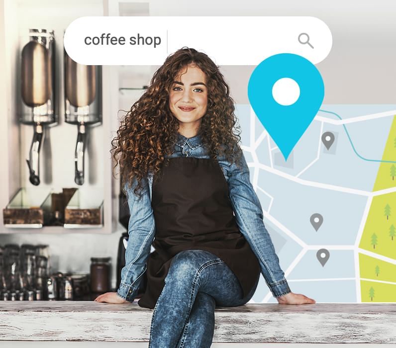 Young lady sitting on a desk of her coffee shop.